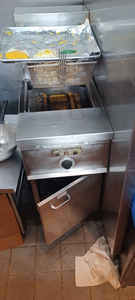 Commercial deep fryer being serviced