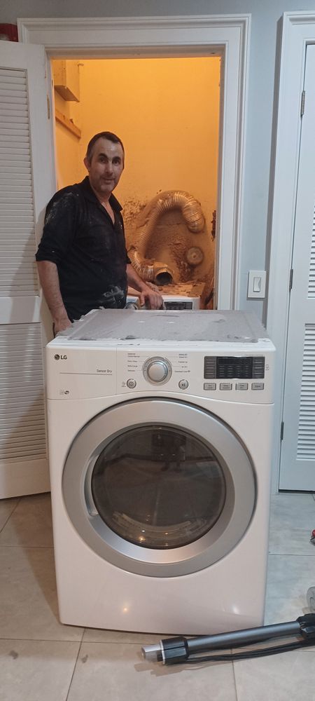 Antonio of AM Appliance's Doctor LLC with a front-load washer after service